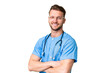 © luismolinero - Young nurse man over isolated chroma key background with arms crossed and looking forward