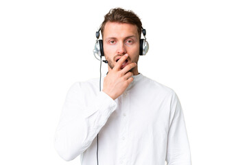 Wall Mural - Telemarketer caucasian man working with a headset over isolated chroma key background surprised and shocked while looking right