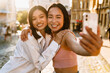 © Drobot Dean - Two young beautiful smiling happy asian girls taking selfie