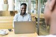 © Westend61 - Happy businessman having meeting with customer in cafe