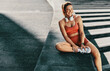 © Jacob Lund - Woman taking a break from her workout outdoors