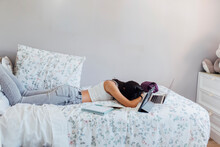 Girl Taking Nap With Wireless Technologies On Bed At Home