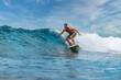 Shirtless male surfer on a wave at sunny day