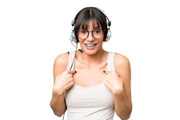 Canvas Print - Telemarketer caucasian woman working with a headset over isolated background with surprise facial expression