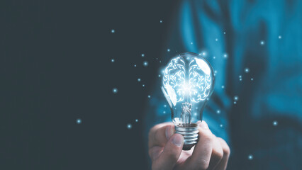 Wall Mural - Businessman hand holding lightbulb with glowing virtual brain and connection line to creative smart thinking for inspiration and innovation with network concept.