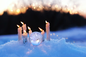Poster - magic quartz ball and candles on snow, winter natural blurred background. christmas, new year wonderful  season. spiritual healing crystal practice. witchcraft ritual for winter solstice, Yule