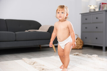 Canvas Print - Cute baby learning to walk in living room