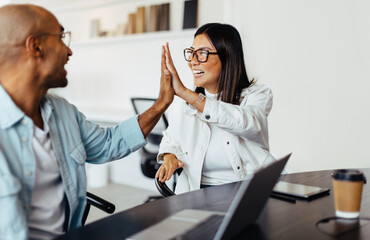 Poster - Business people giving each other a high five in an office