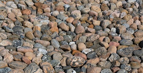 Sticker - Closeup shot of a pile of brown gray rocks