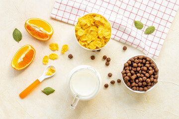 Wall Mural - Children breakfast with snack - cereals with oranges, top view