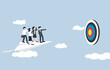 © Yossakorn - Leadership to reach target, team guidance to work in right direction, mentorship concept, Businessman manager on paper plane leading employees to big target.
