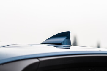 Modern car radio antenna. Shark fin antenna. Modern car roof.