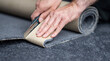 Handyman cutting a new carpet with a carpet cutter...