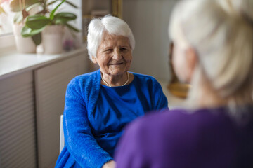 Sticker - Woman spending time with her elderly mother at home
