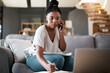 © T Hover/peopleimages.com - Woman, call and laptop budget planning conversation with online financial consultant to help with taxes on living room sofa. Black woman, work from home and remote internet fintech banking consulting