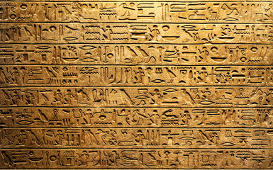 Wall Mural - Old Egyptian hieroglyphs on an ancient background. Wide historical and culture background. Ancient Egyptian hieroglyphs as a symbol of the history of the Earth.