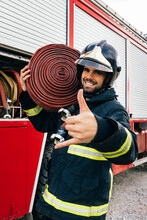 Hispanic Fireman Gesturing Shaka Sign