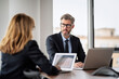 © gzorgz - Group of business people having meeting at the boardroom and working on business report