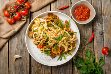 Poster - fried lagman on plate top view on old wooden table