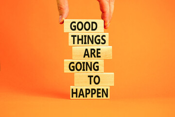 Wall Mural - Good things happen symbol. Concept words Good things are going to happen on wooden blocks on a beautiful orange table orange background. Businessman hand. Business good things happen concept.