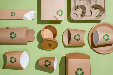 the concept of recycling and zero waste. biodegradable paper tableware for food on a green backgroun