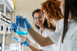 © BalanceFormCreative - Group of young female chemistry scientists doing experiments in lab.