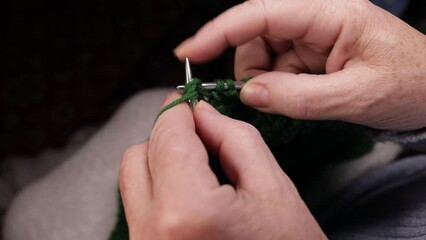 Wall Mural - Woman hands knits with green threads and needles. Handmade hobby knitting and needlework concept