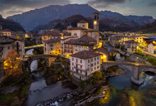 Aerial Villagescape With Mountain Backdrop At Night, San Giovanni Bianco, Val Brembana, Bergamo, Lombardy, Italy