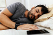© kleberpicui - Man with smart watch sleeping in bed at home