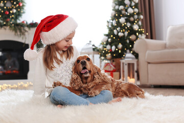 Poster - Cute little girl with English Cocker Spaniel in room decorated for Christmas