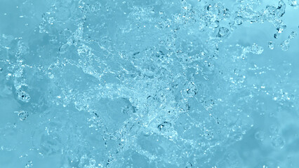 Fototapete - Water splash isolated on soft blue background.