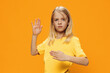 © Tatiana - a cute, beautiful school-age girl in yellow clothes stands on a bright background in a robot pose