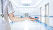 © Rana - Female doctor with hospital or clinic interior blurred for background