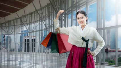 Sticker - Asian woman wearing a traditional Korean national costume, Hanbok, standing while holding a shopping bag