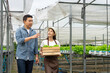 © SKW - An Asian expert in hydroponic gardening is instructing women in proper irrigation and maintenance.