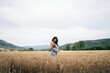 © santypan - Pregnant young woman relaxing in wheat field