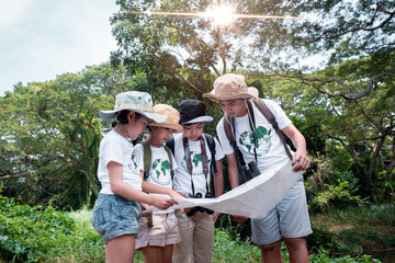 Happy children with binoculars holds hands and looks into distance and something joyfully screams they wearing save world t-shirt with forest nature summer travel holiday concept