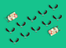 Red Nosed Reindeers And Santa´s Sleigh On Pastel Green Background