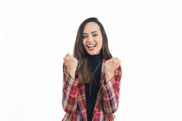 I made it, joyful Latin-American young woman holding her fists and expressing her happiness, medium shot white background. High quality photo