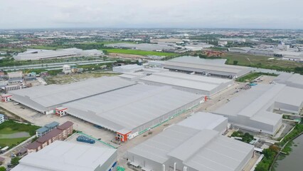 Wall Mural - Aerial top view of industry factory in urban city town. Inventory import and export business commercial, Automobile and automotive industry distribution logistic transport with lake and river.