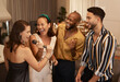 © N F/peopleimages.com - Friends, karaoke party and happy celebration together, dancing and fun reunion in restaurant lounge. Dance, singing happiness and group of people celebrate birthday event, new year or social comedy