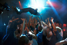 Music Artist, Stage Dive And Concert For Party, Nightclub Or Dance Festival In The Crowd Or Audience Indoors. DJ, Music Concert And Crowds Of People Ready To Catch Performer In Celebration For Event