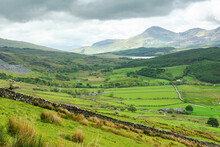 Climbing Up Mountain Range In North Wales, United Kingdom. Rural Landsapes, Green Grass, Cloudy Sky, Selective Focus