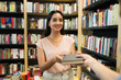 © AntonioDiaz - Happy woman customer buying a new book