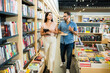 © AntonioDiaz - Young woman and man shopping at the book store