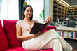 © AntonioDiaz - Portrait of an hispanic woman enjoying a novel at the book shop