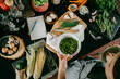 © Maskot - Hand of female chef holding bowl of fresh green peas by counter in studio kitchen