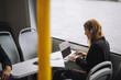 © Maskot - Female entrepreneur typing on laptop while sitting in ferry