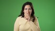 © Robert Peak - Portrait of caucasian hipster woman 20s put finger to lips shh quiet isolated on green screen background studio
