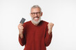 © InsideCreativeHouse - Happy cheerful caucasian mature middle-aged man bank client customer using credit card for online payments cashback discount sale offer isolated in white background